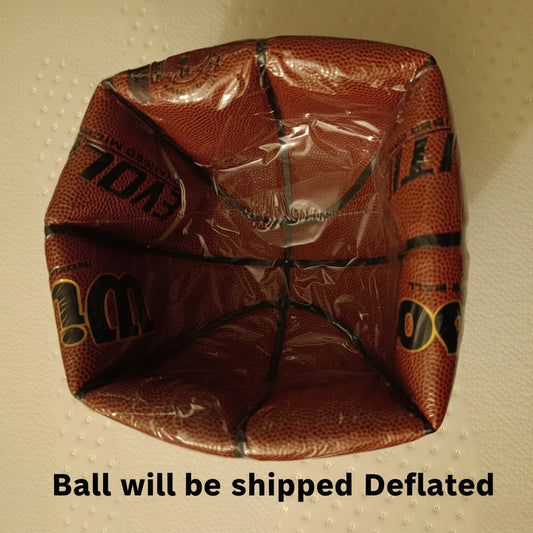 Deflated basketball with visible branding on a textured beige background