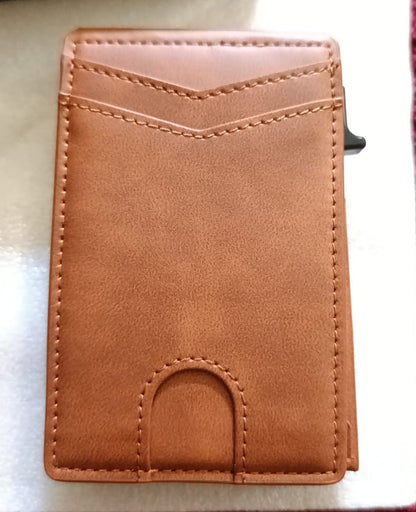 Brown leather wallet on a striped fabric background