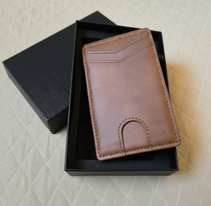 Brown leather wallet in a black box on a textured surface