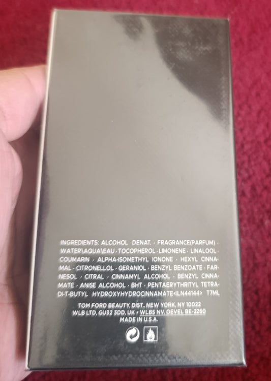 Product packaging held by a hand on a red background