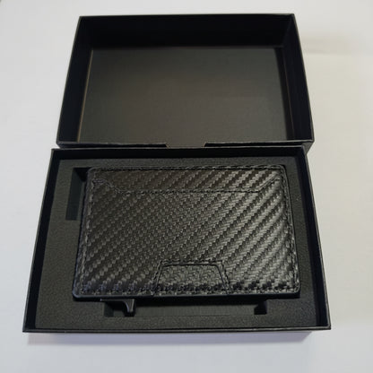 Black carbon fiber wallet in a black box on a white surface