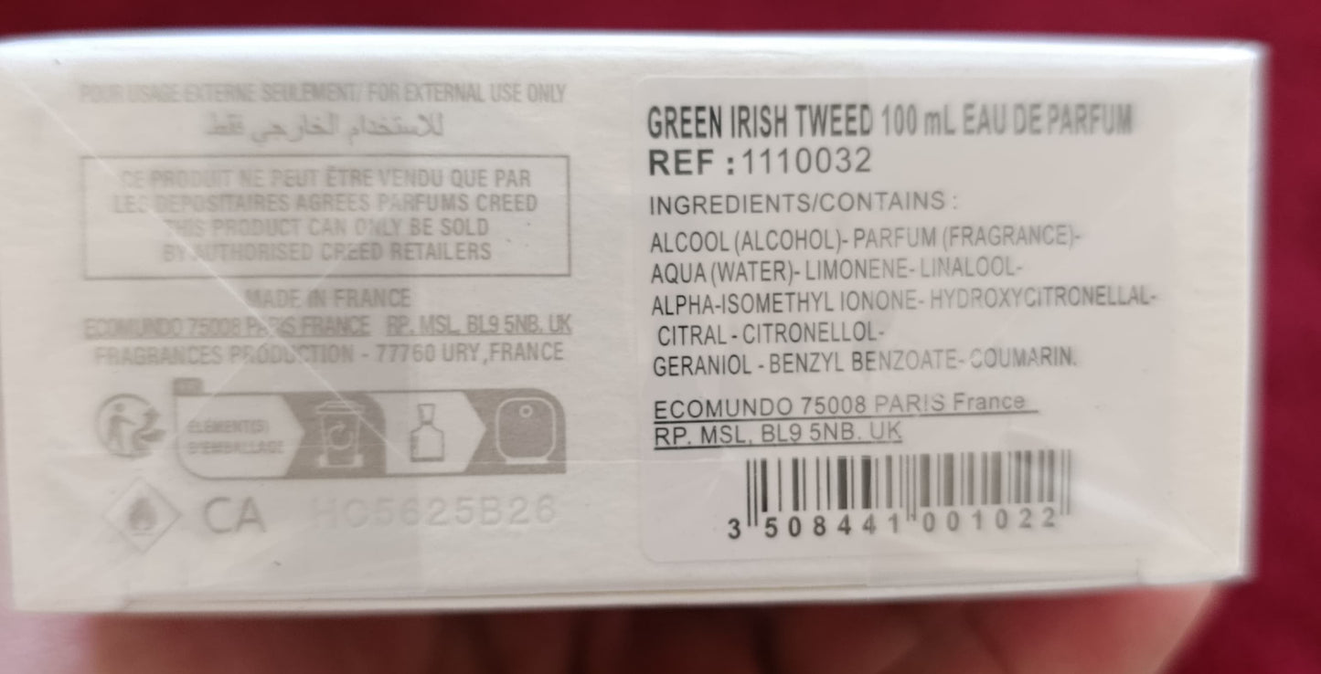 Product packaging held in a hand with a red background