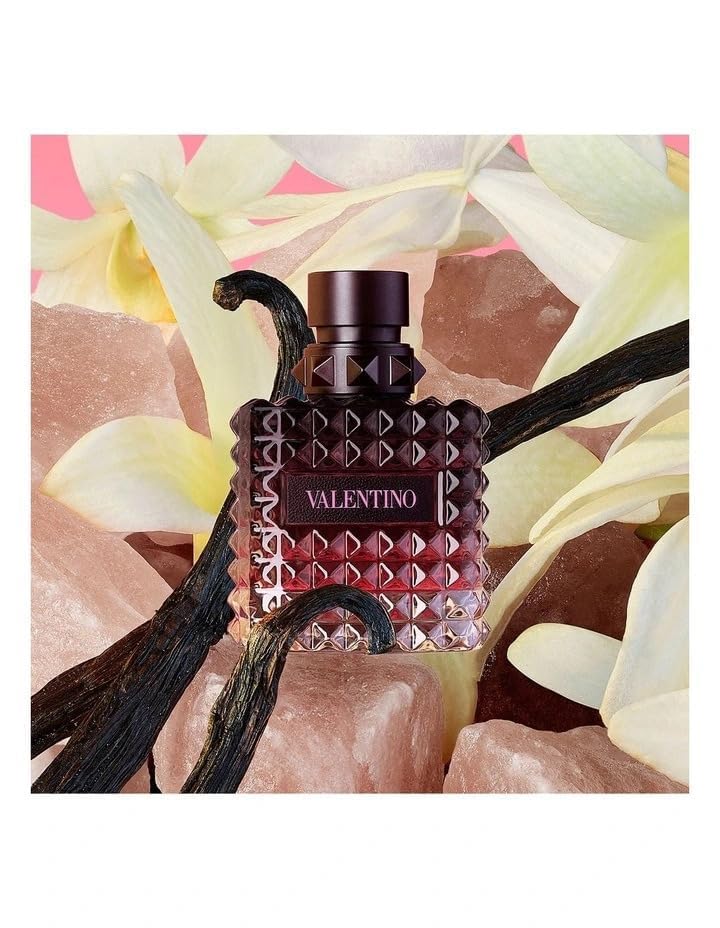Valentino perfume bottle with floral and rock background