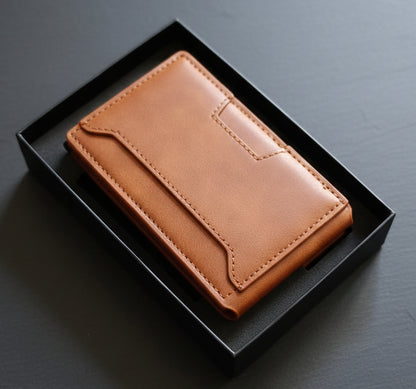 Brown leather wallet in a black box on a white cloth with a red textured background